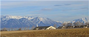 Church and Homes With Mountains in Background